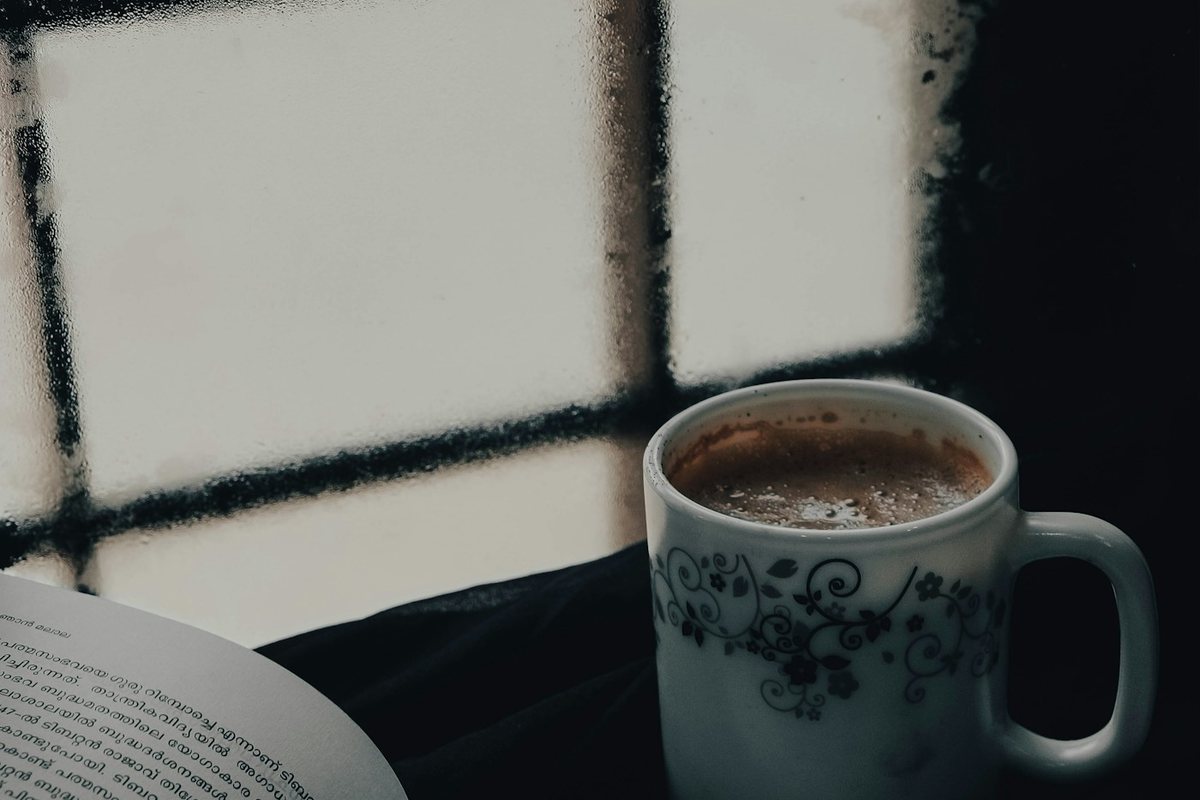 white ceramic mug on black table