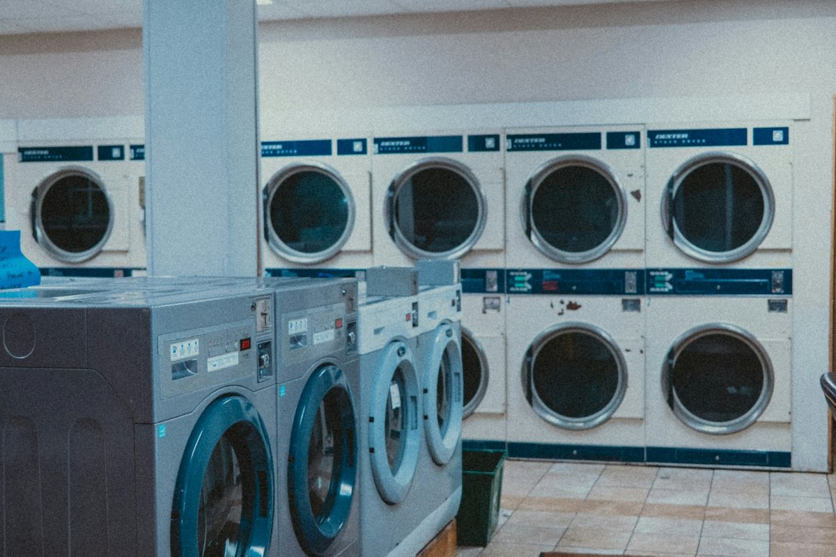 A laundromat with rows of washing machines