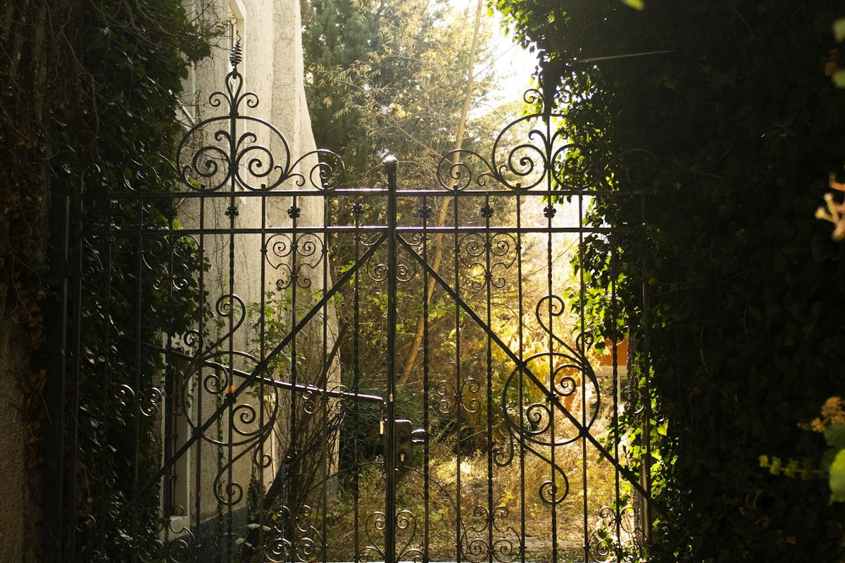 a gate that is open to a garden