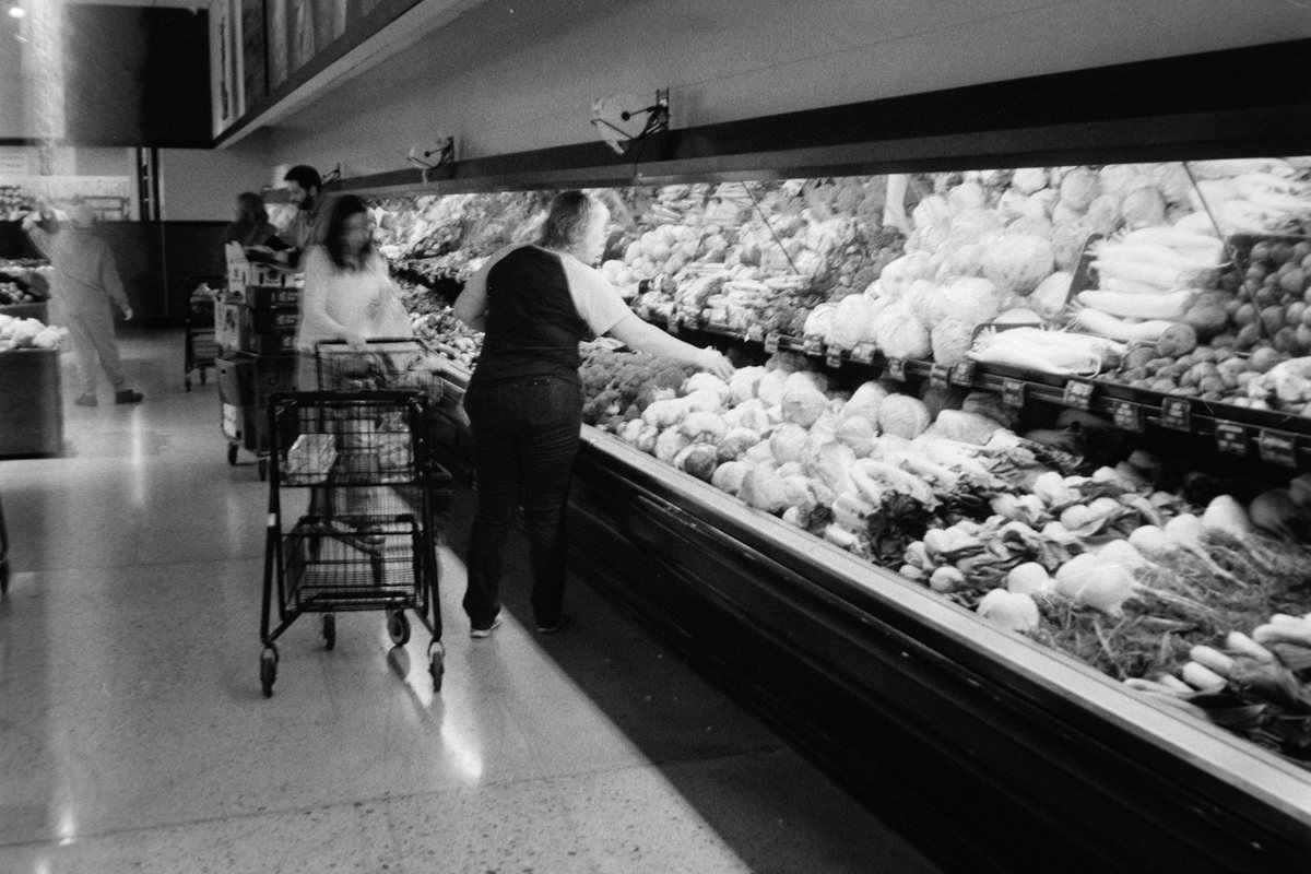 People shopping for produce in a grocery store