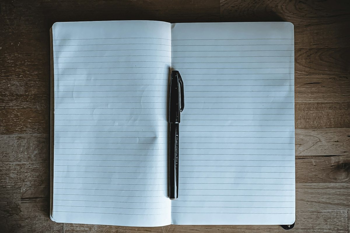 black click pen on white notebook